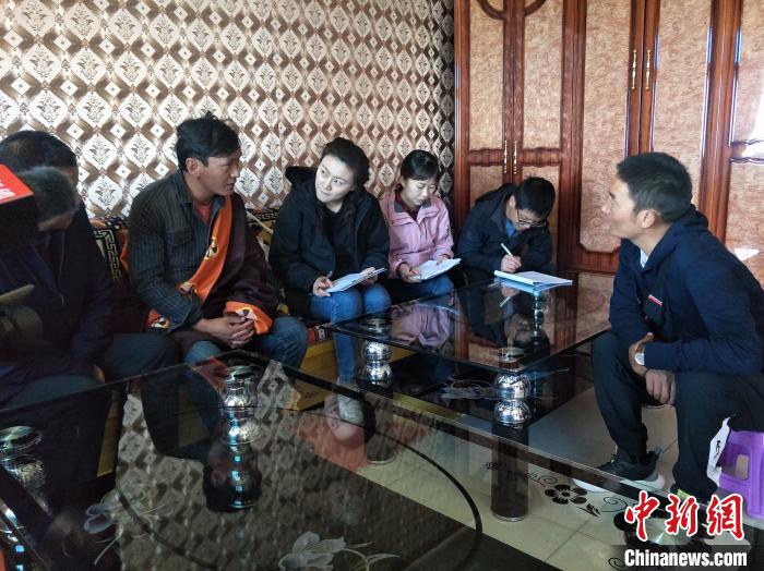 圖為調(diào)查組工作人員正在入戶調(diào)查?！∑钤鲚?攝