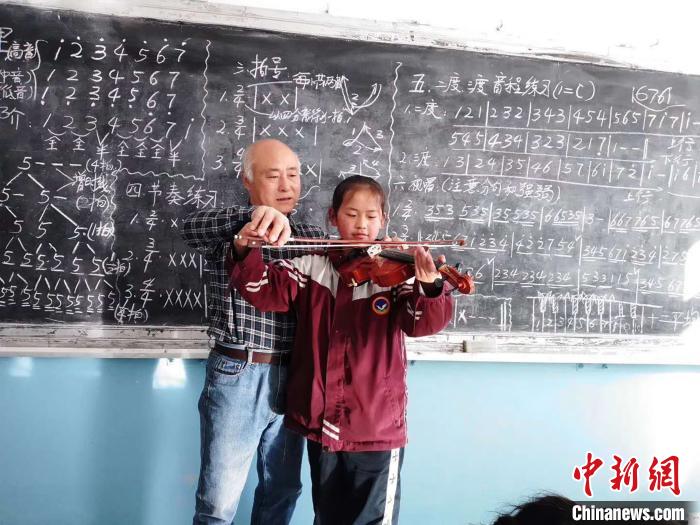 圖為趙興洲教學(xué)生拉小提琴。受訪者提供
