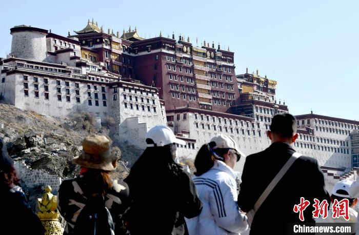 4月17日，游客在拉薩布達(dá)拉宮觀景臺(tái)拍照留念。　李林 攝